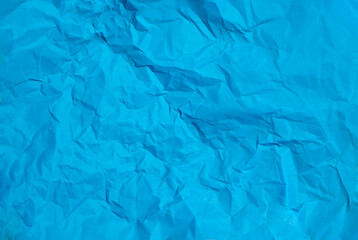Crumpled blue paper abstract background texture