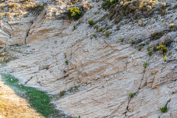 Curious rock formations on the side of a mountain, with detail of the veins and sedimentation layers.
