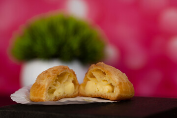 Japanese Cream Puff cut opened with blurred background. Selective focus points