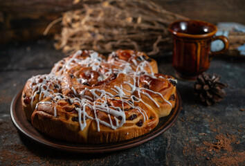 Freshly baked sweet buns on black board on grey stone background