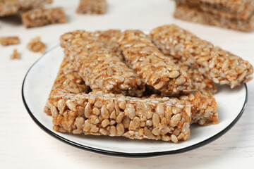 Delicious sweet kozinaki bars on white wooden table, closeup