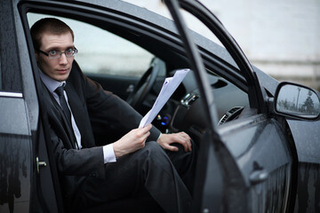 Man in a business suit in the car