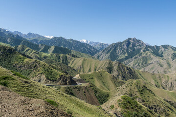 Mountains and grasslands along G217 highway in Xinjiang, China in summer