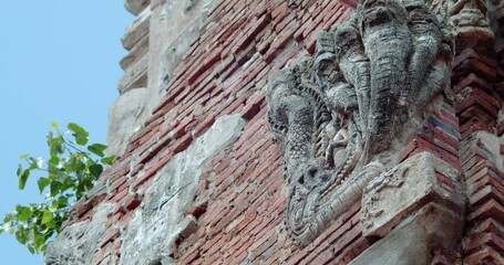 Buddha and Naga statues on old stupa in Thailand. It was built during the Ayutthaya period, about 600 years ago. Wat Phra Sri Mahathat. The Buddhist Temple in Suphan Buri Province. 