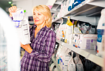 female choose pet food in zoo store