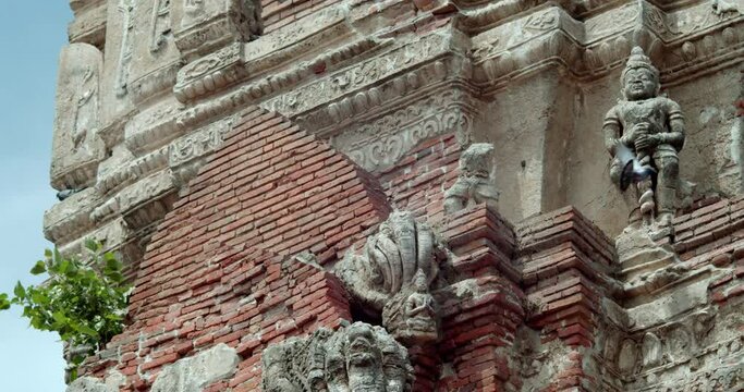Giant, deva clasping hands and Naga statues on old stupa in Thailand. It was built during the Ayutthaya period, about 600 years ago Wat Phra Sri Mahathat. The Buddhist Temple in Suphan Buri Province. 