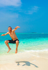 Funny tourist enjoys vacation on island Madivaru Finolhu Rasdhoo Maldives.