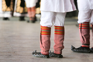 Legs of people in ethnic  folcloric clothing. Dancers in national costumes. 