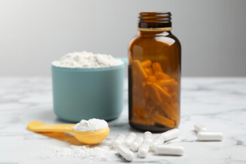 Amino acid pills and powder on white marble table