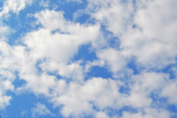 Bright blue sky with white fluffy clouds