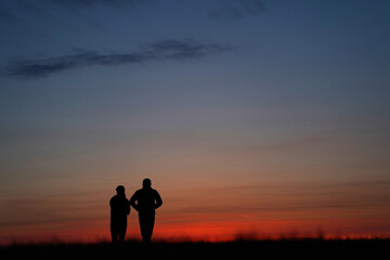 a couple of people after sunset