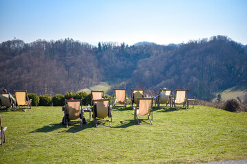 View of chaise-longues in nature looking at forests and hills