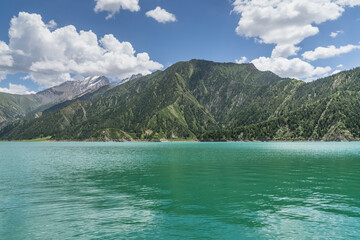 Snow mountains, grasslands, forests and lakes along G217 highway in Xinjiang, China in summer