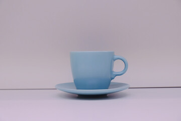 Blue ceramic coffee tea cup against white background for branding mock up. For kitchen, cafe, retail store template scene; merchandising display; blank mockup