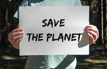 Save the planet text on placard in hands. 