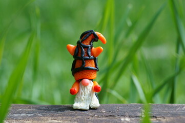 A figure of a dwarf with an orange striped hat.