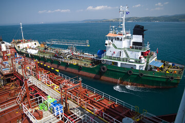 Slop barge approaching small tanker
