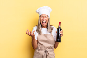 middle age chef woman looking angry, annoyed and frustrated screaming wtf or what’s wrong with...
