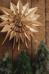Merry Christmas ! Stylish christmas star and little pine trees on rustic old wooden background....