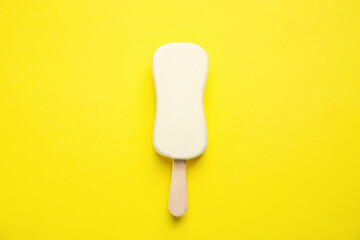 Ice cream with glaze on yellow background, top view