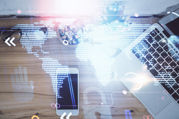 Double exposure of map hologram drawing over desktop. Top view. International connection concept.