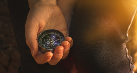 Obraz na płótnie Canvas Traveler using compass in the woods