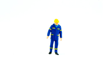 Miniature people engineer worker construction concept on white background