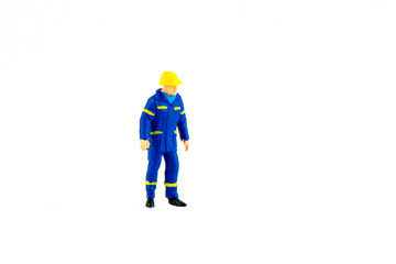Miniature people engineer worker construction concept on white background