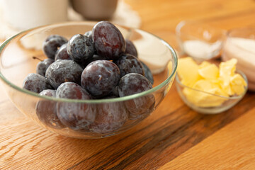 Home cooking baking plum cake with ingredients on wooden table, top view