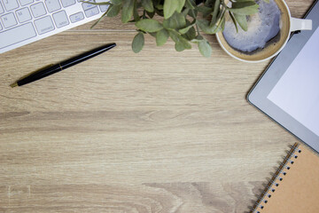 Working items, notebook and pen on wooden table