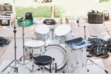 Fototapeta na wymiar White drums and cymbals on an empty stage