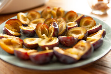 sliced halves of sweet purple plum on a plate