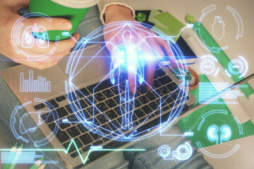 Double exposure of woman hands typing on computer and general theme hologram drawing. Education concept.