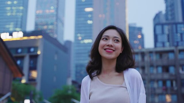 pretty young happy asian woman walking at city urban city at summer evening travel concept