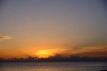 Papier Peint photo Plage de Seven Mile, Grand Cayman Perfect end of the day on the west end of the Cayman Island of the British West Indies looking out over the ocean and beautiful clouds