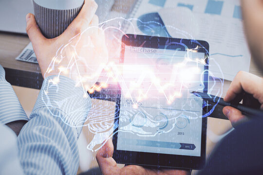 Double exposure of man's hand holding and using a digital device and brain hologram drawing. Data concept.