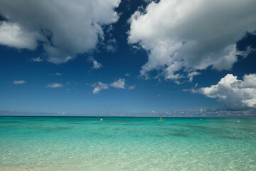 Crystal clear waters and pinkish sands on empty seven mile beach on tropical carribean Grand Cayman...