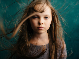 little girl loose hair Green background dissatisfaction emotions