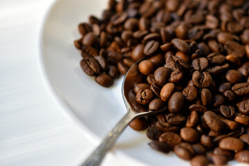 Coffee beans close-up on a white plate