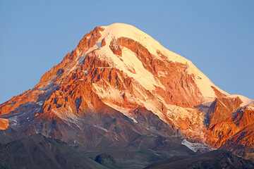 Obraz premium Snow Covered Peak of Mount Kazbek as Seen from the Town of Stepantsminda, Georgia