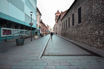 Man walking by a narrow street