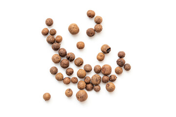 Allspice, grains of allspice or black pepper isolated on white. Scattered pepper, top view