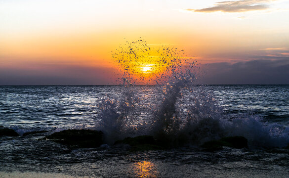 Ocean waves crashing against the coastal stones at sunset - Chillaw, Sri Lanka