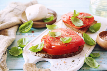 Beef heart tomato toast with olive oil, basil and mozzarella, two servings