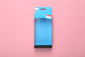 Blank packaging box with transparent front on pink background