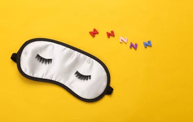 Türaufkleber Sleeping mask with eyelashes on yellow background. Healthy sleep concept © splitov27