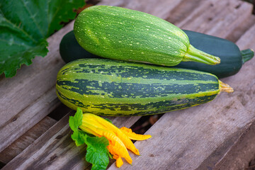 three zucchini lie on a wooden board