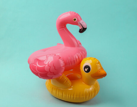 Inflatable duck and flamingo on a blue background. Pool party. Summer concept. Creative layout
