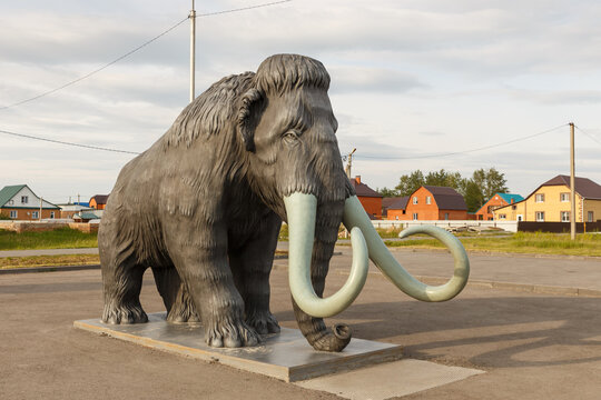 Abatskoe village, Tyumen region, Russia - June 12, 2021: A statue of a mammoth on the square of the village of Abatskoye. The village of Abatskoye is the capital of paleontology of the Tyumen region.