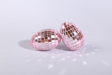 Disco ball, mirrored eggs on a gray background. Easter celebration concept